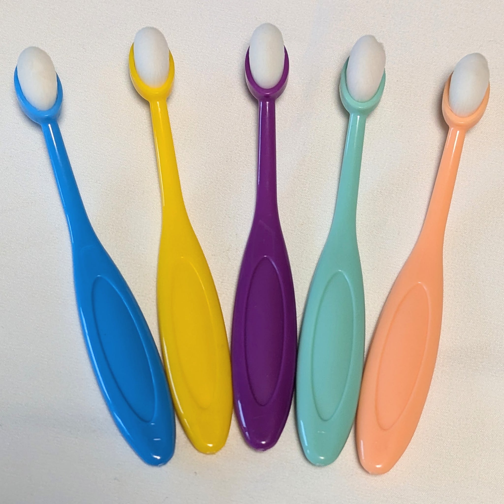Set of five small colorful blending brushes with bright purple, blue, yellow, pink, and green handles—designed for detailed ink work in card making.